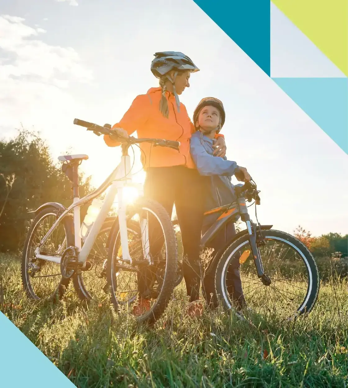 A mother and child take a break from cycling to bask in the sun’s fading light.