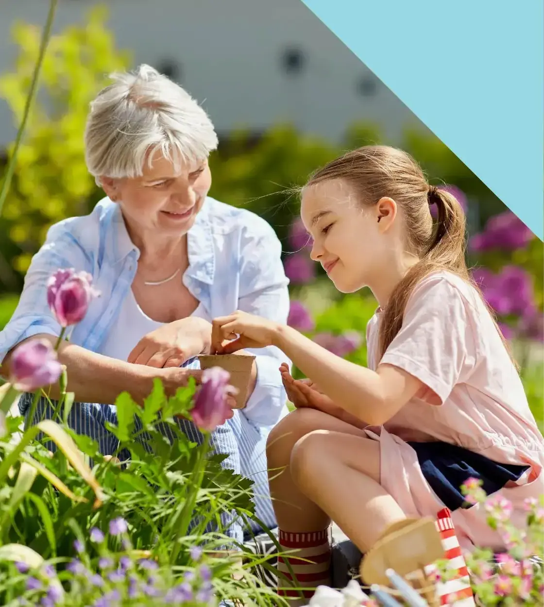 A grandma spends some quality time with her granddaughter by showing her how to plant a garden.