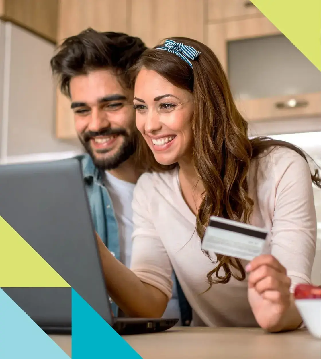 An exuberant couple makes an exciting purchase online using their Conexus credit card.
