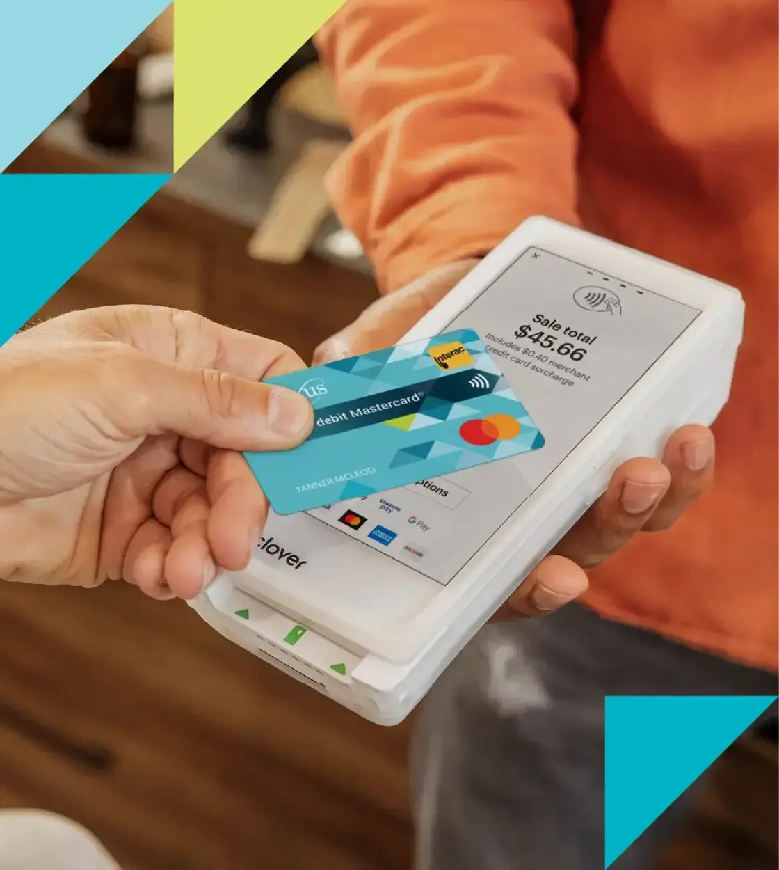 A hand holding a Conexus debit Mastercard taps a debit machine to complete a payment.