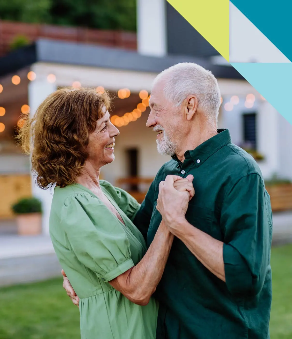 A mature man and woman lock eyes and smile as they savour a romantic dance together.