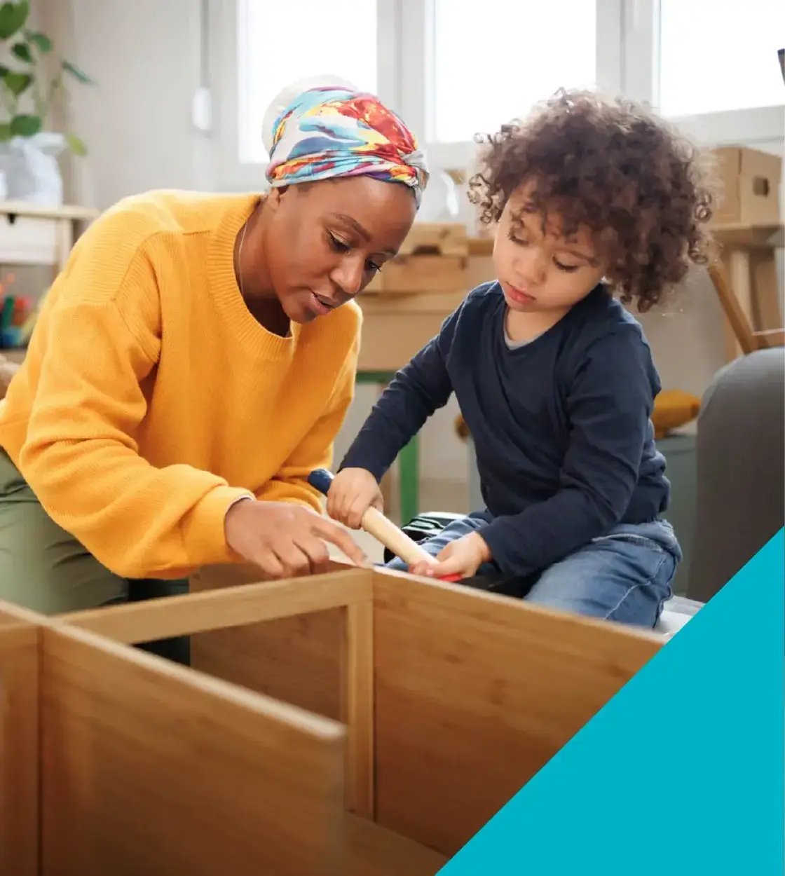 A mother and her young child hammer out a fun construction project together at home.