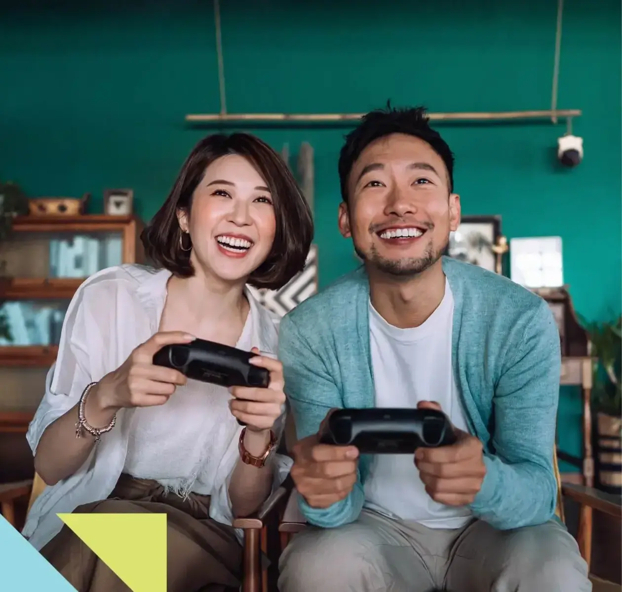 A man and woman share some laughs playing their favourite video game console.