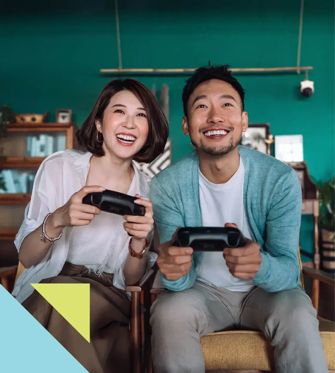 A man and woman share some laughs playing their favourite video game console.