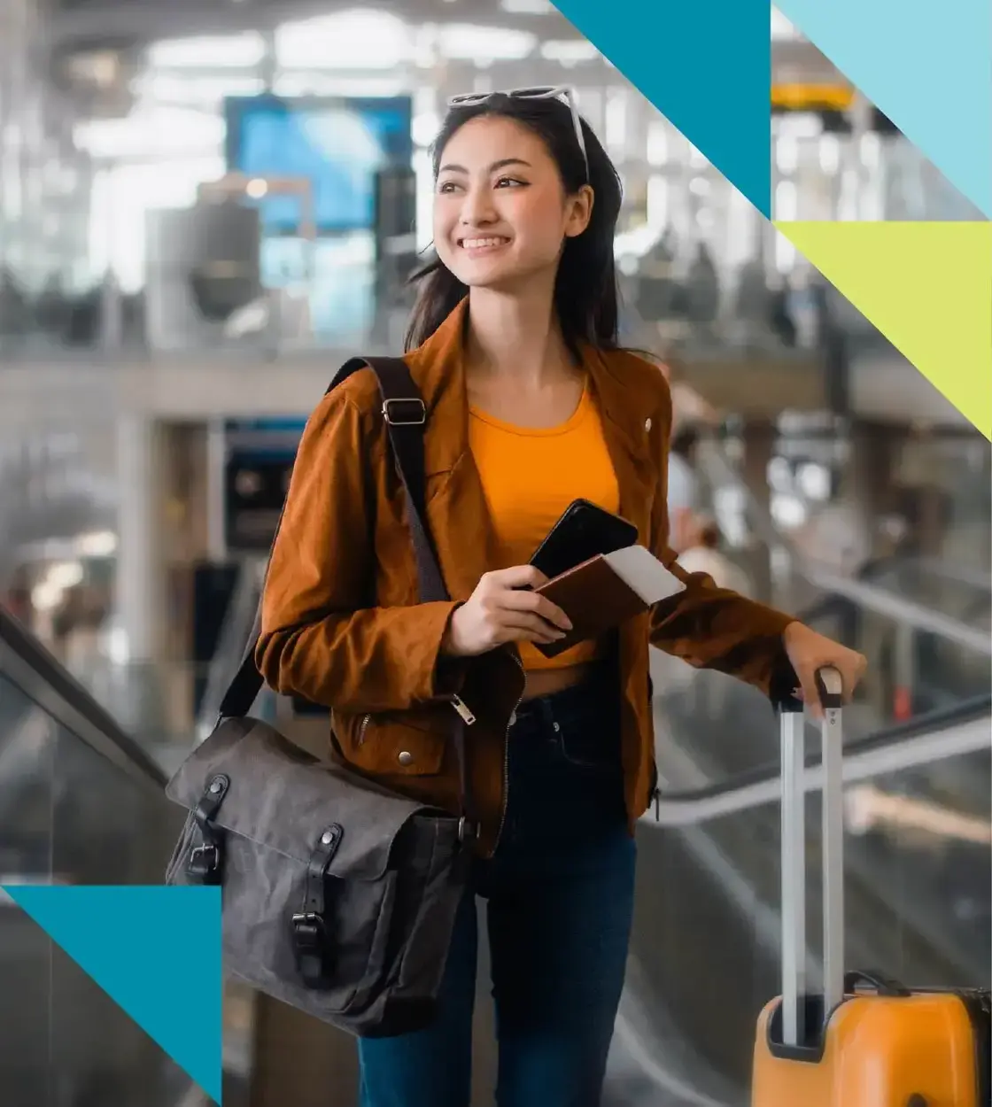 A young woman toting luggage beams with joy as she makes her way through the airport.