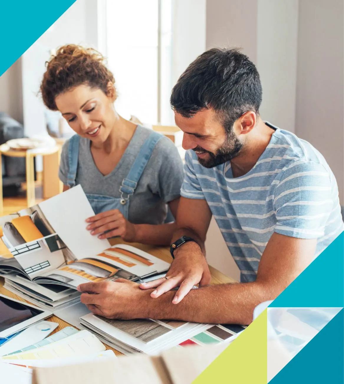 A man and woman explore interior design options on a kitchen table.