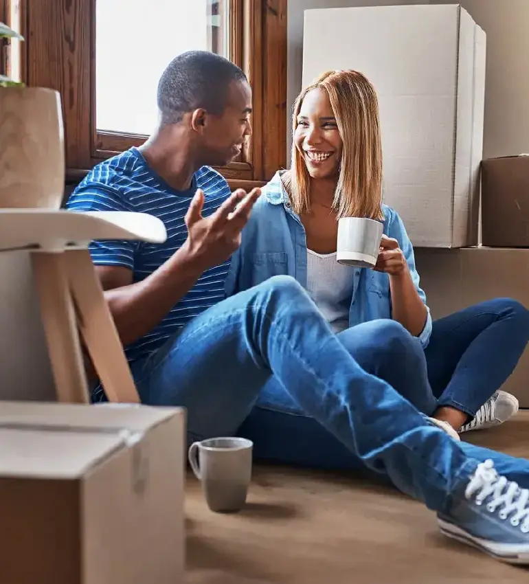 A young couple takes a well-earned coffee break from moving into their new home.