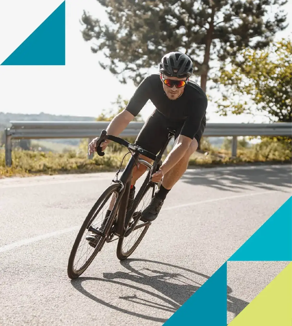 A male cyclist rounds a corner on his ride along a country road.