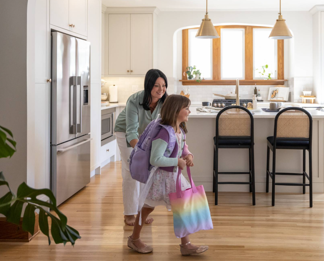A parent and child together in their kitchen