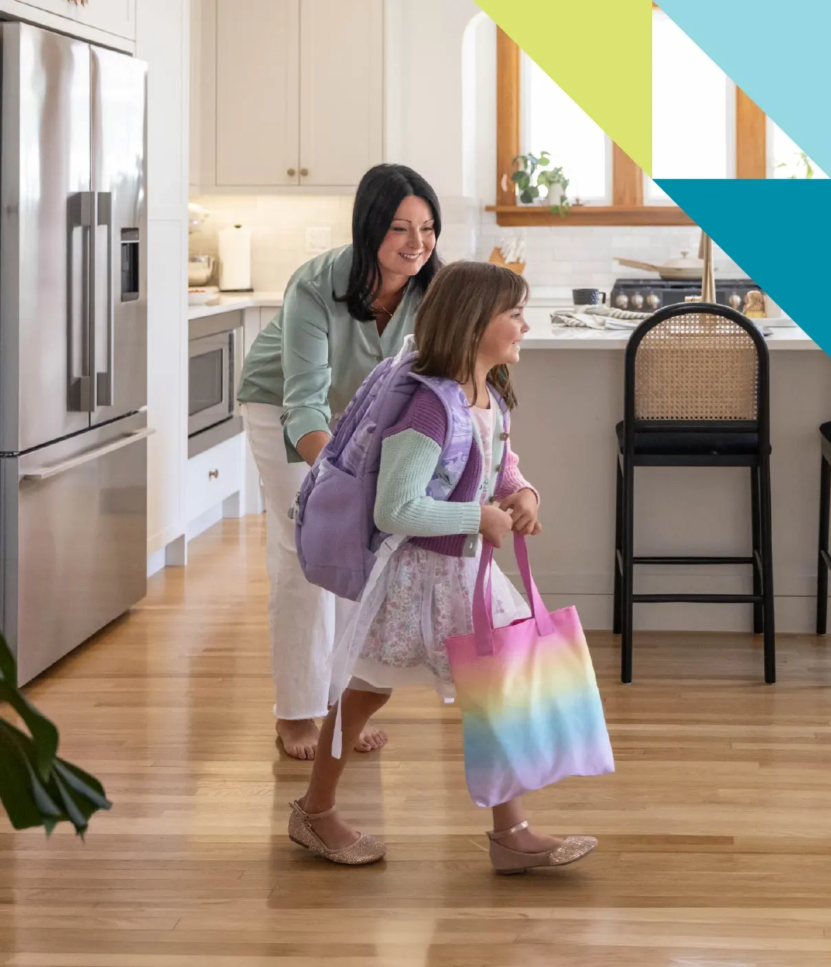 A doting mother sends her smiling daughter off to school for the day.