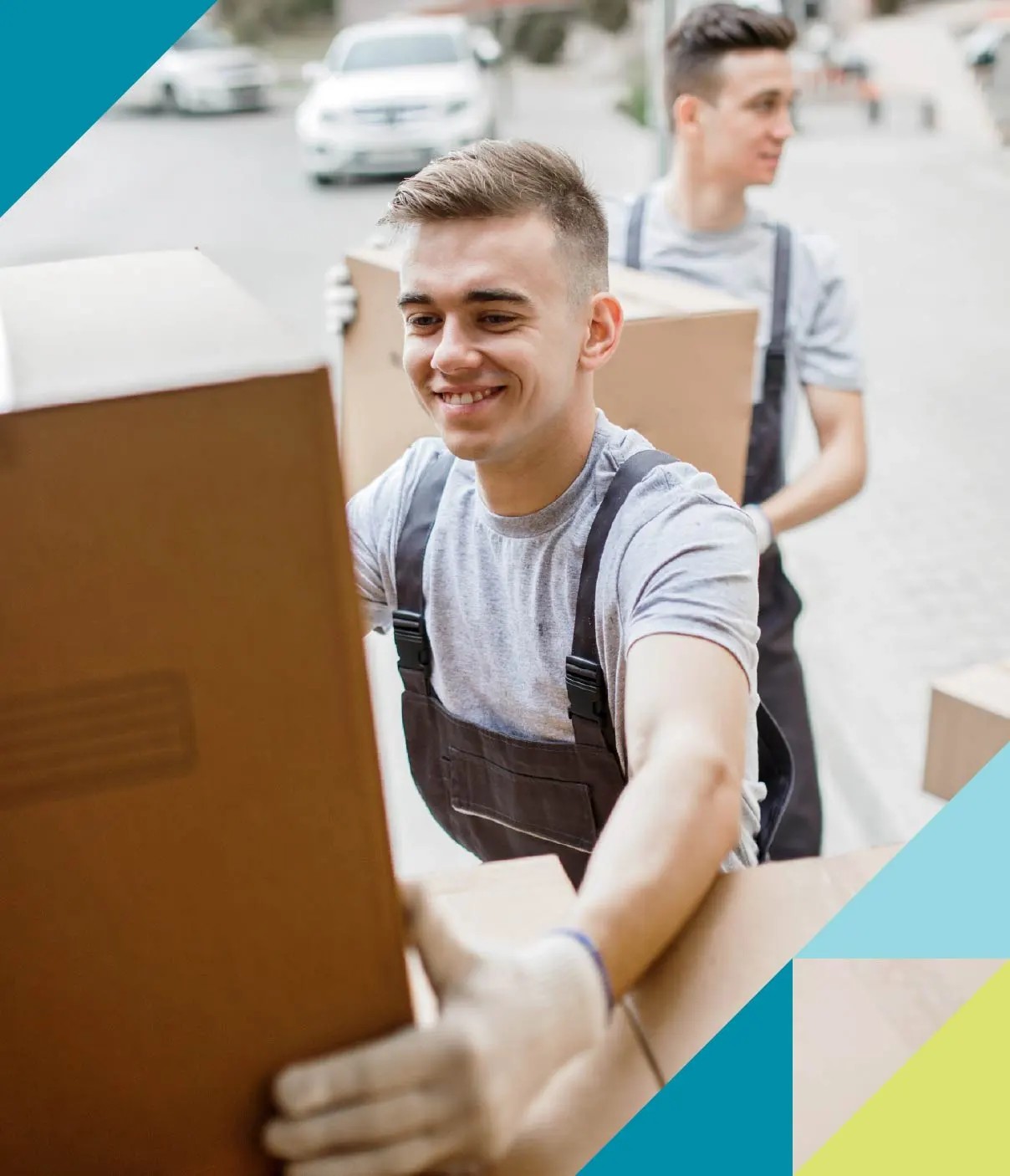 Two young male movers load up boxes.
