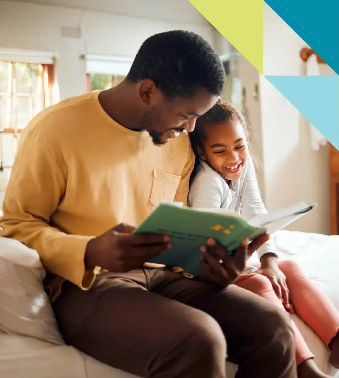 A father takes time to read his young daughter a bedtime story.